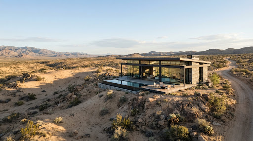 An expansive view of a serene, arid landscape with a solitary, modern glass and steel structure blending into the desert environment. Earthy color palette, wide angle, conveying isolation and high-end design.