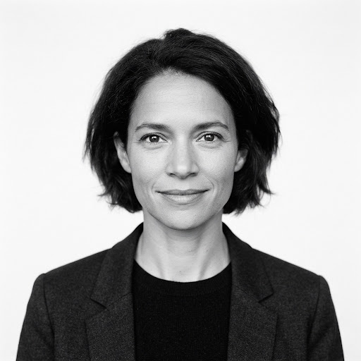 A minimalist black and white headshot of a female writer. She is looking directly at the camera with a serene, intelligent expression. The background is pure white. The lighting is soft and flat, emphasizing an authentic, raw, and highly professional editorial style typical of avant-garde literary journals.