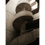 A minimalist architectural photograph of a brutalist concrete staircase winding upwards. Deep shadows and stark highlights, monochromatic warm tones, emphasizing form and structure in an editorial style.