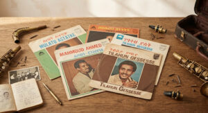 Overhead shot of vintage vinyl record sleeves and brass saxophone parts laid on an oak table in Addis Ababa